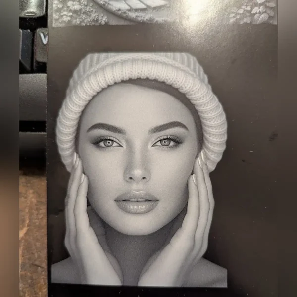 Photo portrait engraved on a black metal card with a 5W UV laser